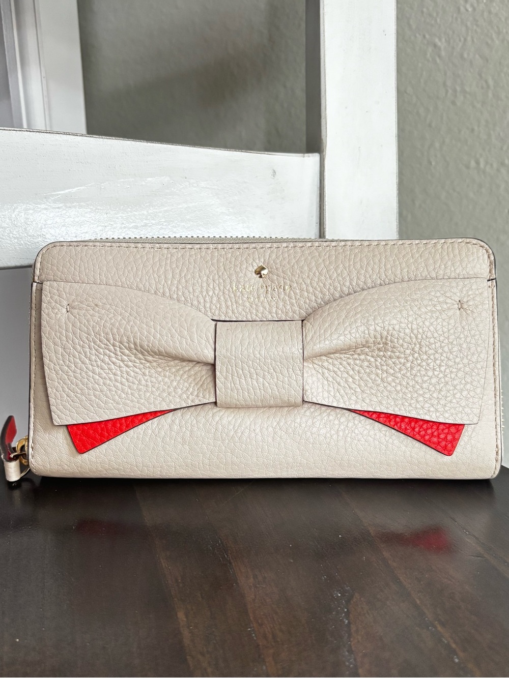 kate spade Cream Leather Bow Zip Wallet with Orange Accent